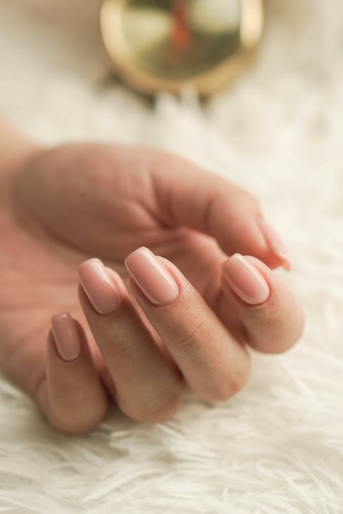 Short nude nails on a soft background
