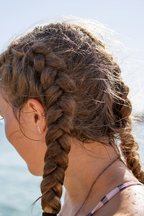 Two easy braids on long hair at the beach
