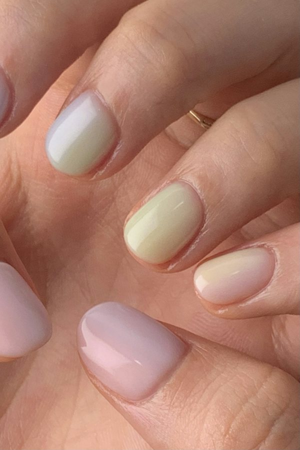 Close-up of a soft pastel manicure in lilac, mint and pink