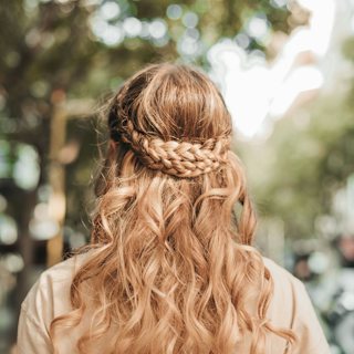 Half-up braided hairstyle with soft waves