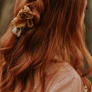 Braided half-up hairstyle on long auburn hair